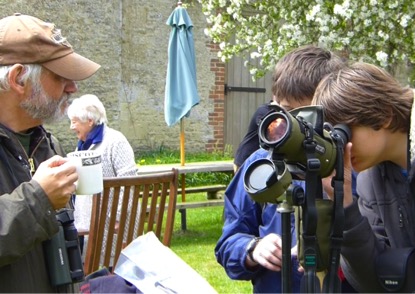 Image: Watching the rookery at Kelmscott Manor. EWA Director Dr Andrew Gosler, Oxford University, tells two of the Young Carers about the former use of rook chicks as food in England  (Photo: Roberto Thomson, Oxford University)